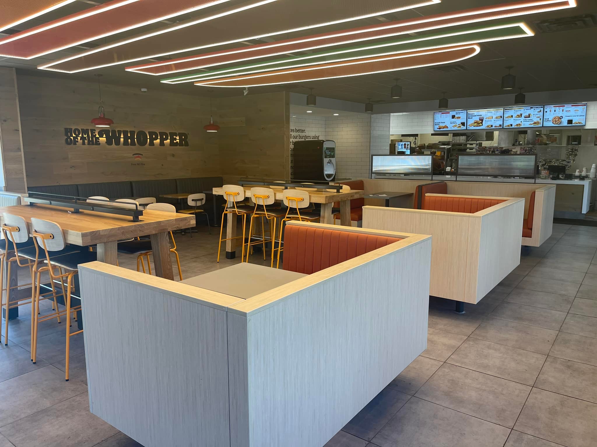 Remodeled Burger King interior with modern seating booths, updated lighting design, and new front counter layout