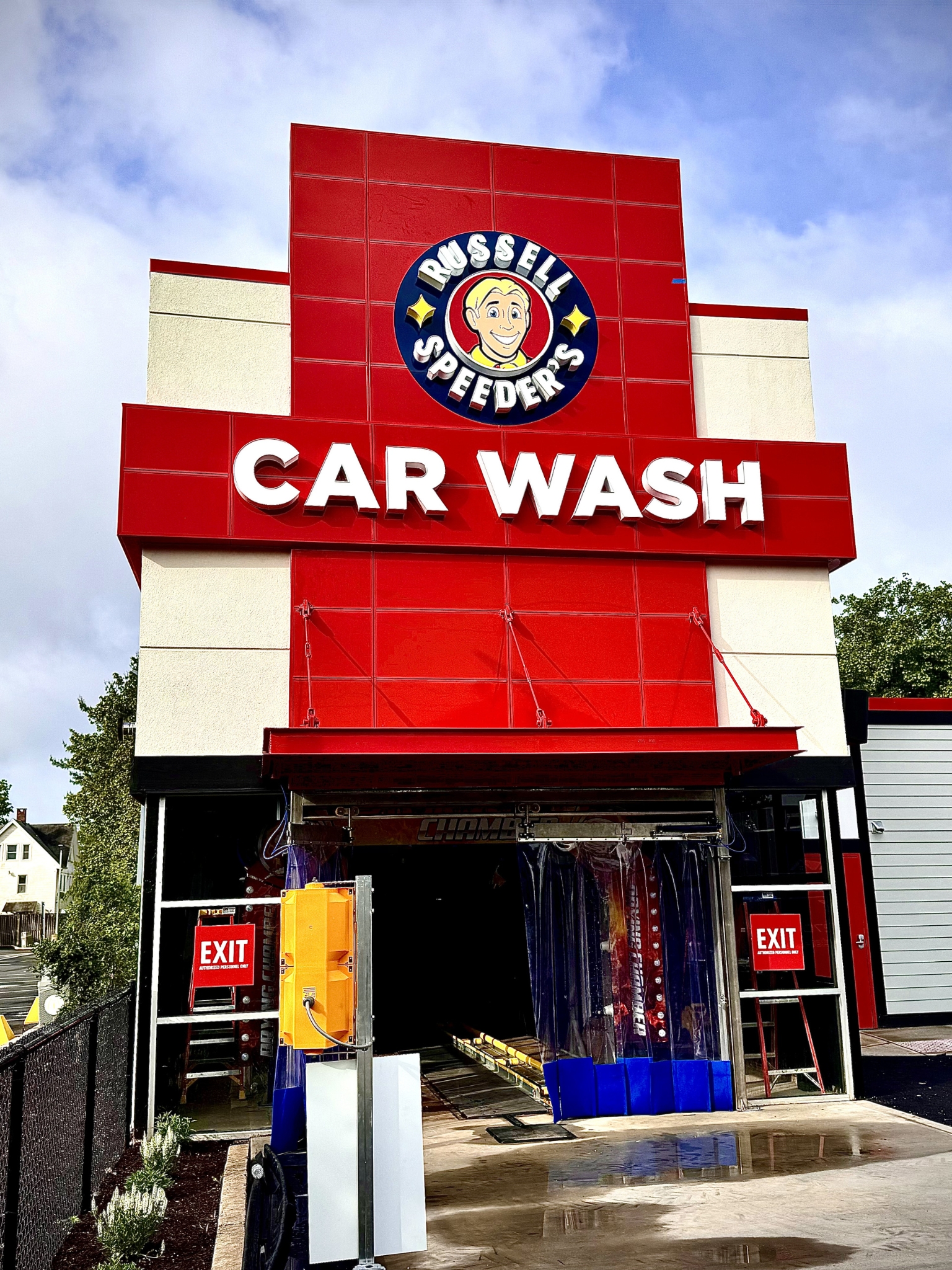 Restaurant interior under renovation with new ceiling installation, booth seating, and construction materials on site